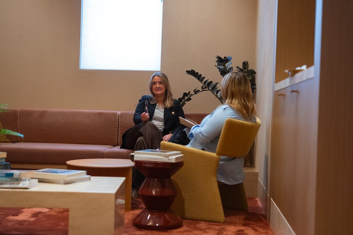 A client and psychologist talking in a warm consulting room